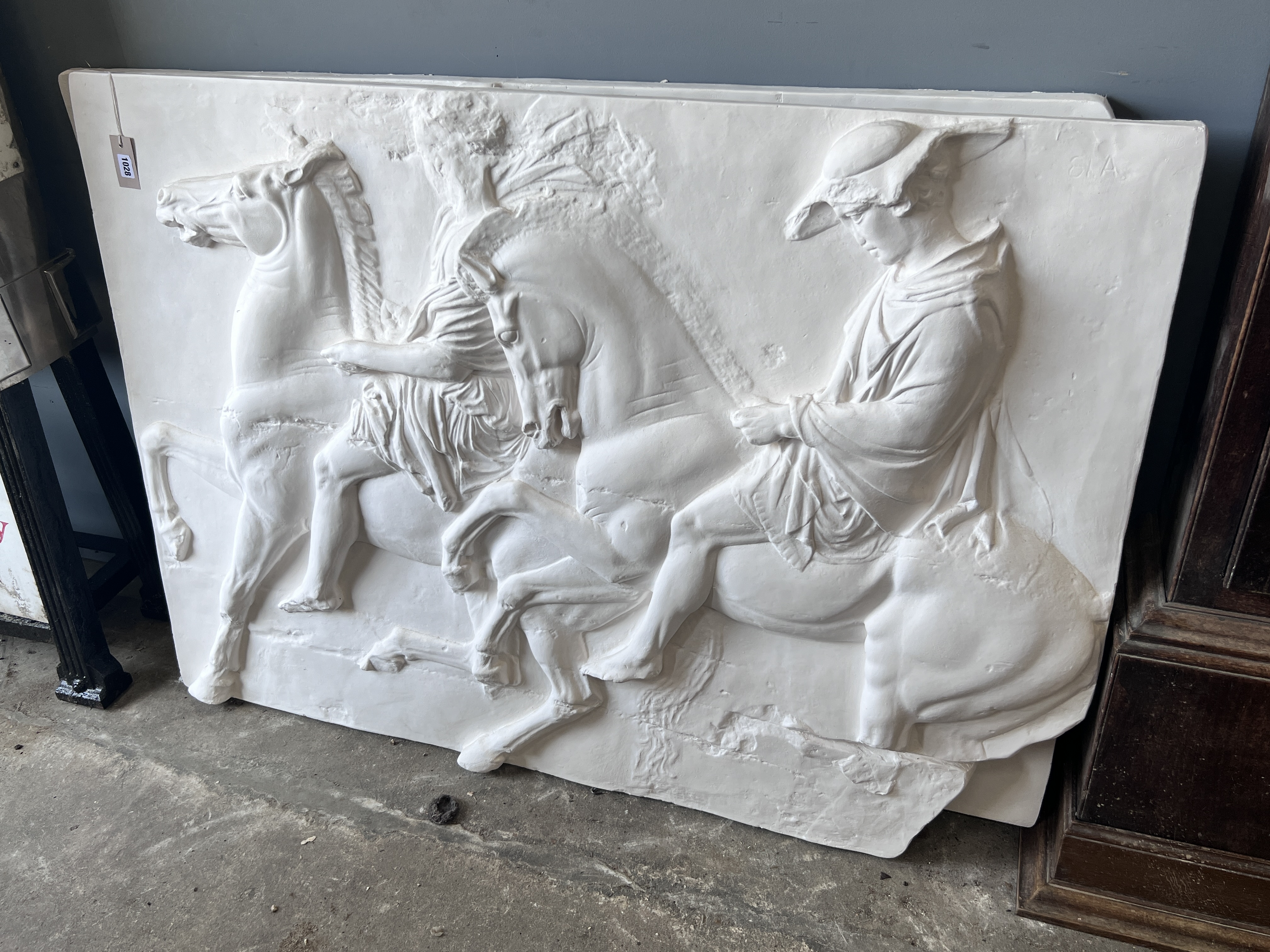 A pair of cast plaster panels of horsemen, each panel width 140cm, height 100cm